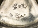 a close up of a silver plate with a stamp on it
