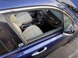 a blue car that is parked in a parking lot