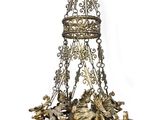 an antique brass chandelier with a crown and angels