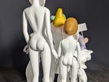 figurines of a group of people standing next to each other on top of a table