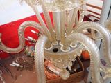 a chandelier made of glass and metal in a room