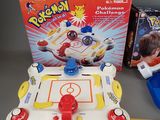 a small table with a game on it next to a phone