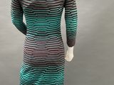 a mannequin dress with green and black stripes on a mannequin mannequin mannequin mannequin mannequin mannequin manne