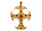a close up of a gold cross with black and red stones