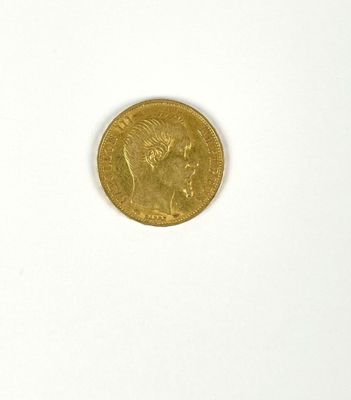 a gold coin on a white surface with a white background