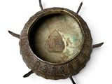 a metal bowl with a picture of a man on it