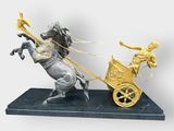 statue of a man on a horse pulling a cart with a woman on it