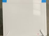 a white board with blue tape on it sitting on the floor