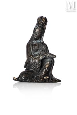 an image of a statue of a woman sitting on a rock
