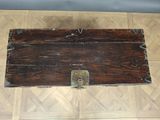 a wooden box on the floor with a lock on it