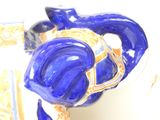 a figurine of a horse that is blue and gold