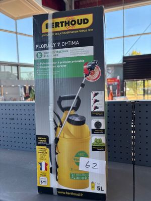 the box of a yellow sprayer is sitting on a table