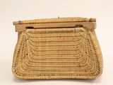a close up of a wicker purse on a white background
