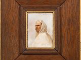a painting of a man in a white robe in a wooden frame