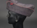 a black mannequin head wearing a gray hat with a red line on it