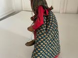 figurine of a woman in a blue and red dress holding a basket