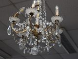 a crystal chandelier hanging from the ceiling in a room