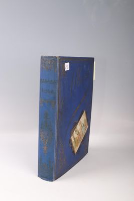 an old blue book sitting on top of a white table