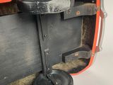a close up of an orange suitcase with a black handle