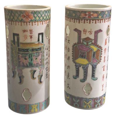 pair of chinese vases with oriental designs on them against a white background