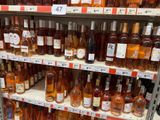 bottles of wine on a shelf in a store for sale