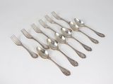 six silver spoons and a fork on a white surface