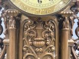 a gold clock that is sitting on top of a table