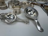 a lot of silver spoons and other silverware on a table