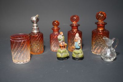 five glass bottles with figurines in them on a table