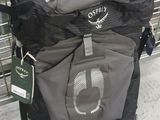 a black and grey backpack with a tag on it