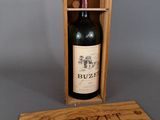 wooden box with a bottle of wine in it on a gray surface