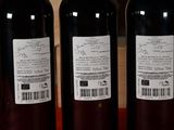 three bottles of wine on a table with a barcode on the label