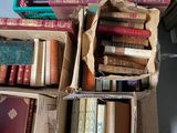 boxes of books are stacked on top of each other on the floor