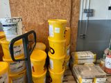 many yellow buckets sitting on a pallet in a room