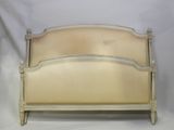 an old white bed with a wooden headboard and foot board