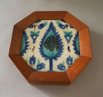 a small wooden box with a blue and white design on it