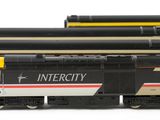 several model trains are lined up next to each other on a white surface