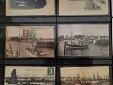 many pictures of boats on display on the wall