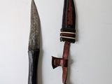 a knife and a knife holder hanging on a wall