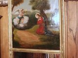 a painting on the wall above a mirror in a room