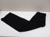 black pants on a white table with a white wall in the background