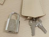a close up of a purse with keys and a padlock on it