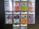 a lot of pokemon cards on display on the wall
