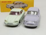 two toy cars sitting next to each other in front of a box