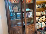 a bookcase with many books on it in a living room
