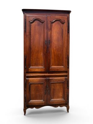 an old wooden armoire with two doors and a drawer