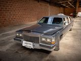 a car that is parked in a garage next to a brick wall