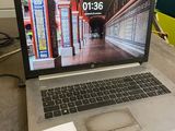 a laptop that is sitting on a table with a sticker on it