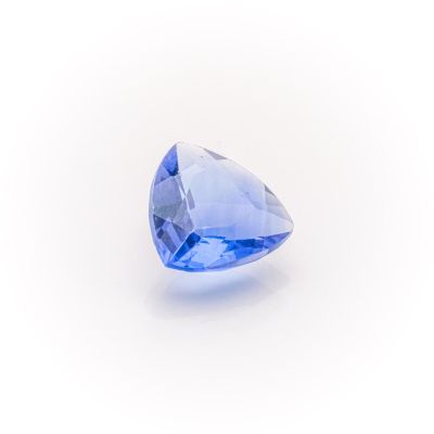 a close up of a blue diamond on a white surface