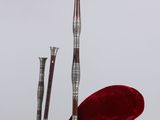 a red bag with a pair of skis on top of it